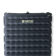The NEMO Equipment Tensor™ Extreme Conditions Ultralight Insulated Sleeping Pad is rectangular, dark, and features horizontal air chambers, a valve in the upper right corner, a central logo, and a high R-value for warmth on cold ground.
