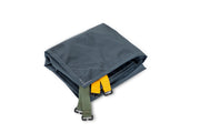 A folded dark gray NEMO Equipment Dragonfly™ Bikepack OSMO™ Footprint, featuring yellow and green straps with black plastic buckles, made of abrasion-resistant, waterproof fabric, set against a plain white background.